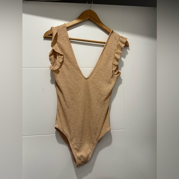 Body suit with ruffle detail. NWT. - Picture 1 of 3